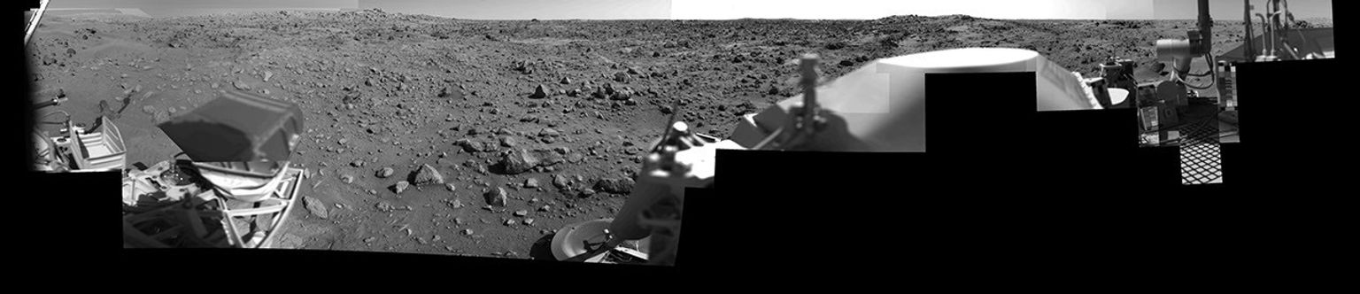 This image was taken by NASA's Viking Lander 1 at Chryse Planitia on Mars. The lander can be seen in the foreground looking toward the rugged martian terrain.