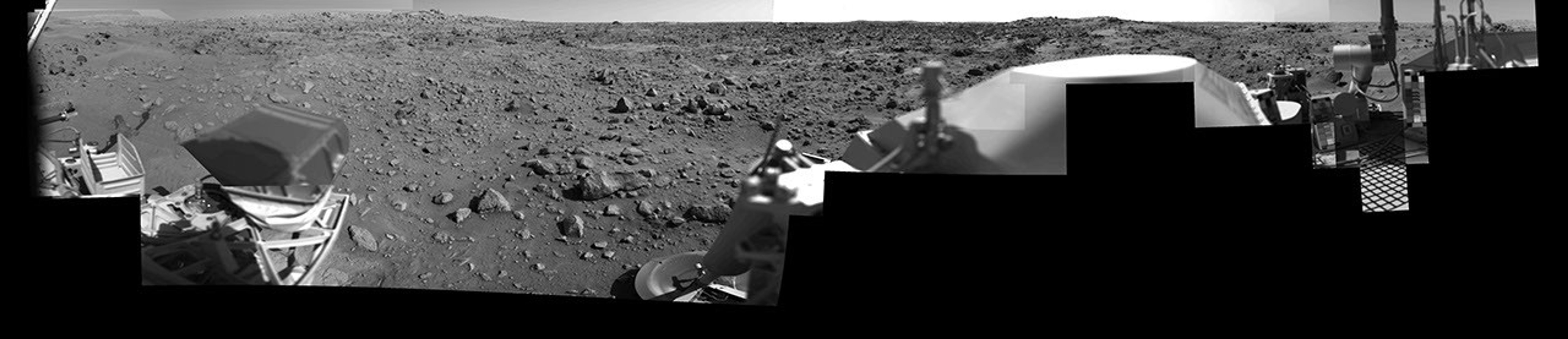 This image was taken by NASA's Viking Lander 1 at Chryse Planitia on Mars. The lander can be seen in the foreground looking toward the rugged martian terrain.