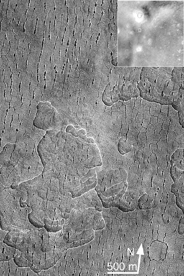 NASA's Mars Global Surveyor shows fractures and pits in the Utopia Plains of Mars.