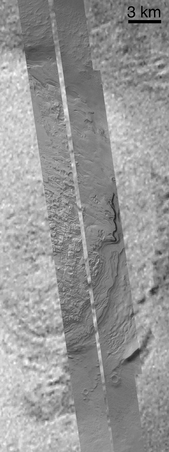 NASA's Mars Global Surveyor shows layered sedimentary rock Spallanzani Crater on Mars.