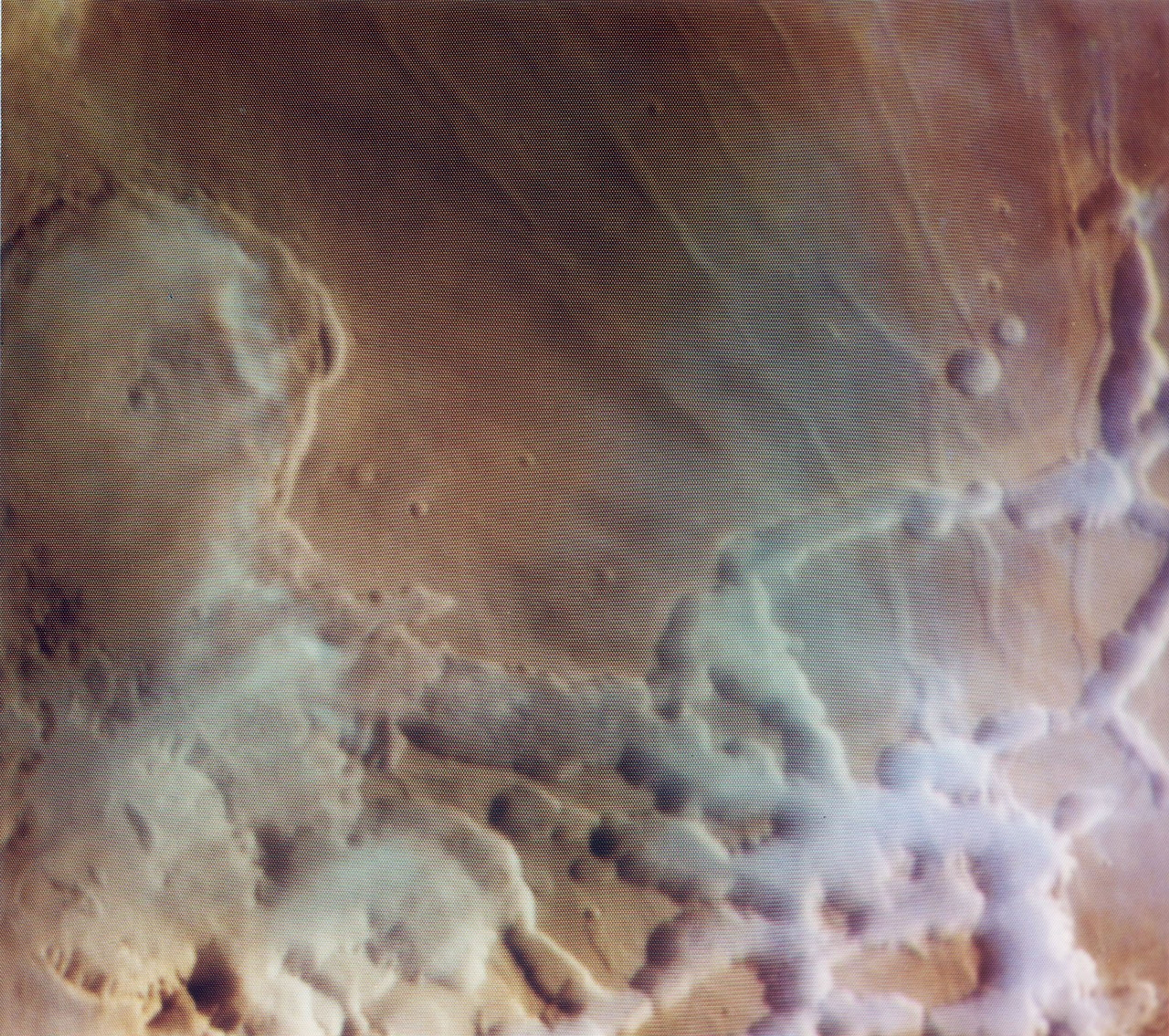 NASA's Viking Orbiter 1 captured the sun rising over Noctis Labyrinthus (the labyrinth of the night), bright clouds of water ice can be observed in and around the tributary canyons of this high plateau region of Mars.