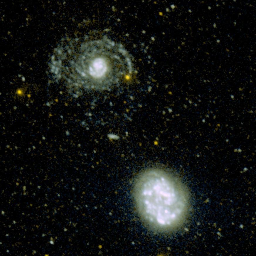 This image shows the hidden spiral arms that were discovered around the galaxy called NGC 4625 (top) by the ultraviolet eyes of NASA's Galaxy Evolution Explorer. An armless companion galaxy called NGC 4618 is pictured below.