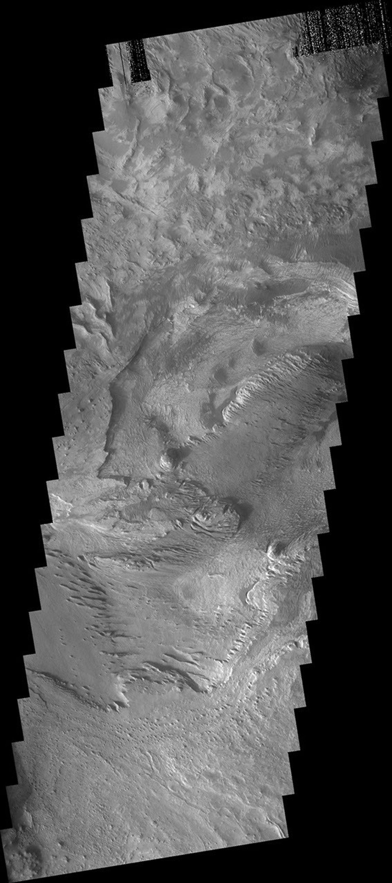 The layered and wind eroded deposits occur on the floor of Chandor Chasma on Mars as seen by NASA's 2001 Mars Odyssey spacecraft.