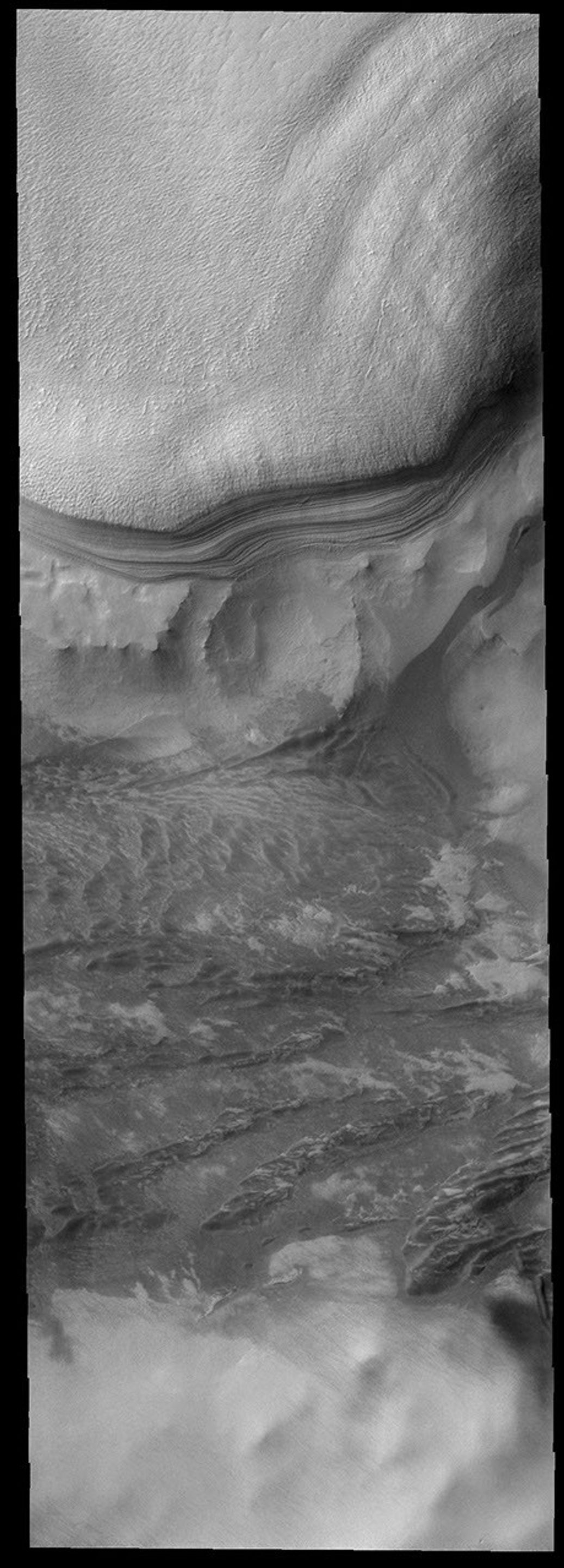 This image shows the margin of the south polar cap on Mars . The polar layers are prominently shown against the rocky surroundings as seen by NASA's 2001 Mars Odyssey spacecraft.