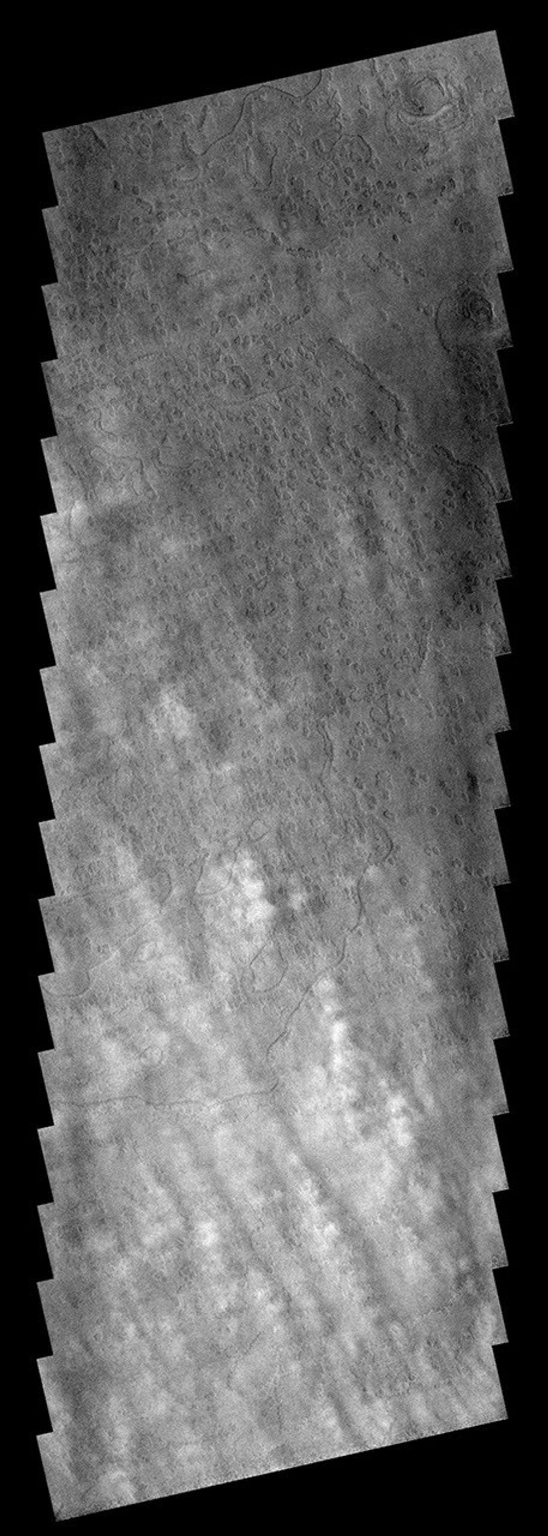 These clouds are located near the edge of the south polar region on Mars . The cloud tops are the puffy white features in the bottom half of the image as seen by NASA's 2001 Mars Odyssey spacecraft.