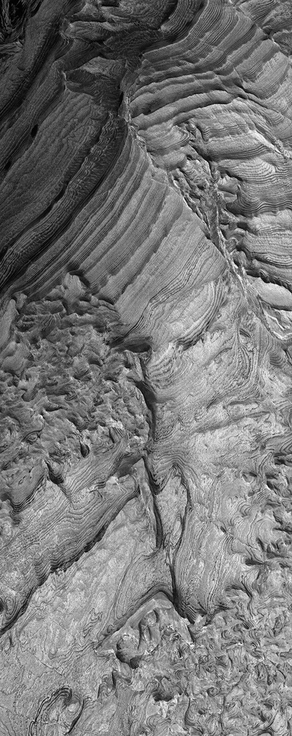 NASA's Mars Global Surveyor shows light-toned, layered, sedimentary rock outcrops in Becquerel Crater in the western Arabia Terra region on Mars.