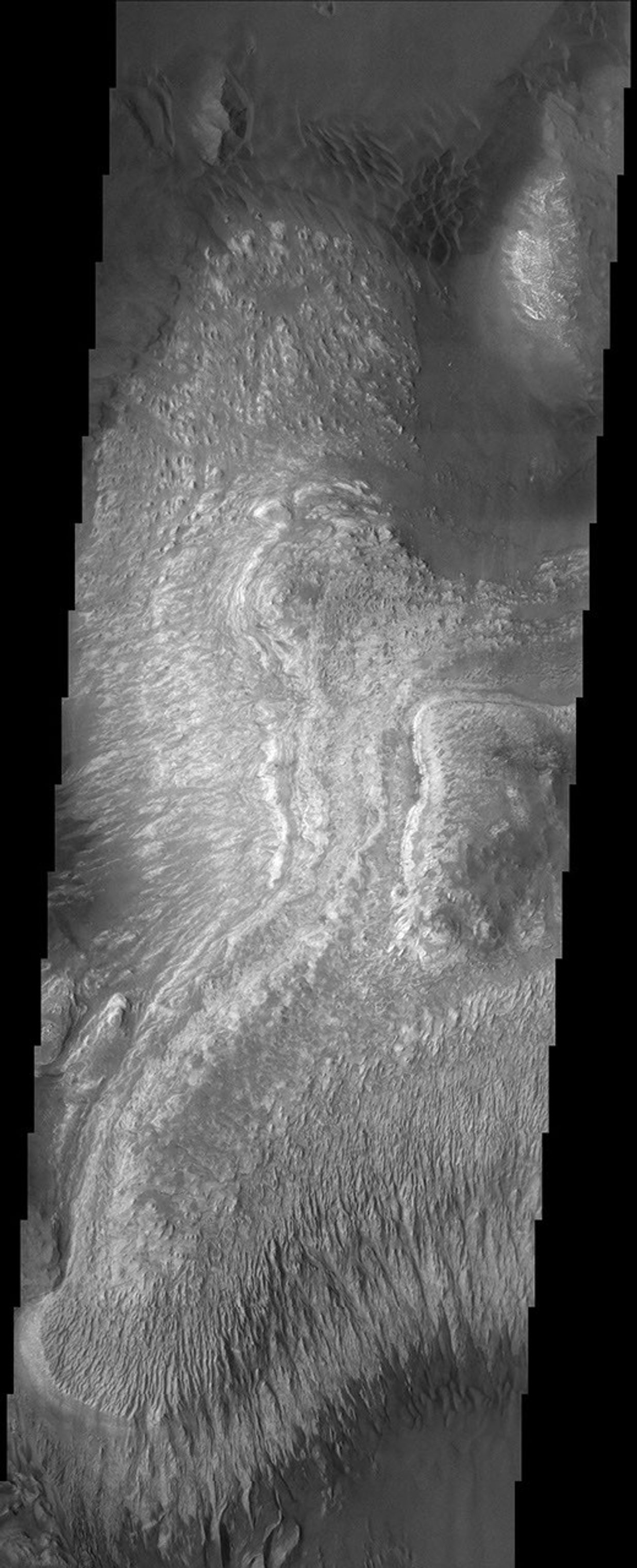 These layered deposits are located on the floor of a large canyon called Ganges Chasma which is a part of the Valles Marineris in this image captured by NASA's 2001 Mars Odyssey spacecraft.