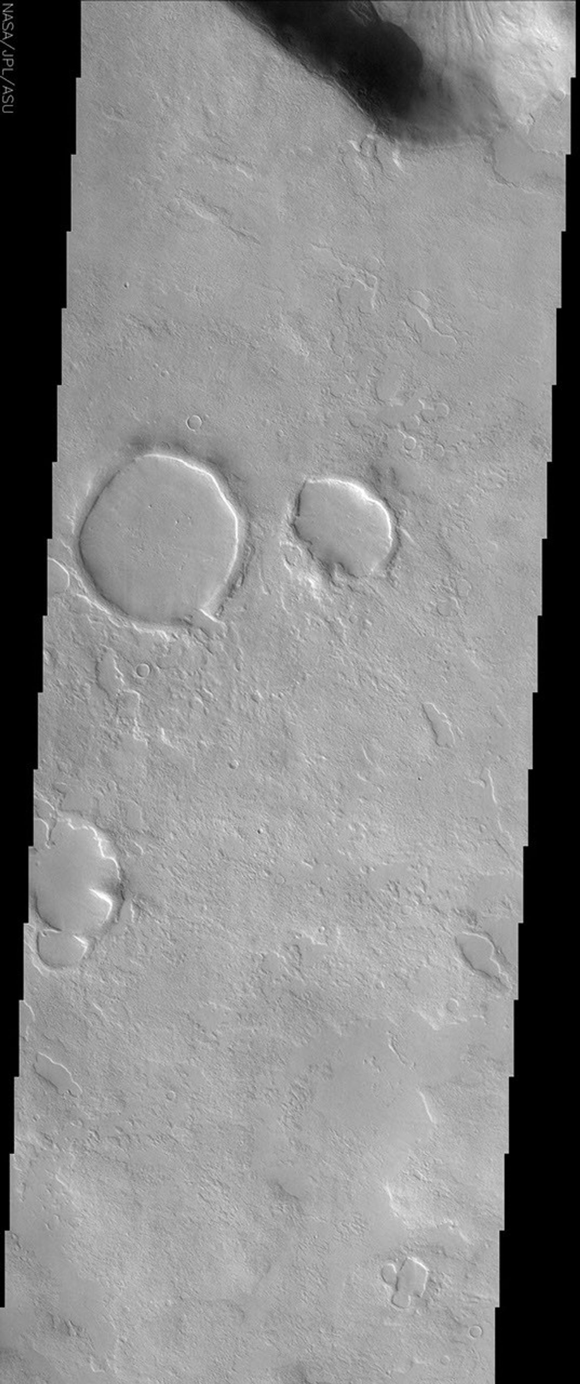 This NASA Mars Odyssey image shows a region in northern Arabia Terra where knobby or 'scabby' plains units that mantle and modify a pre-existing cratered surface dominate the unusual landscape.