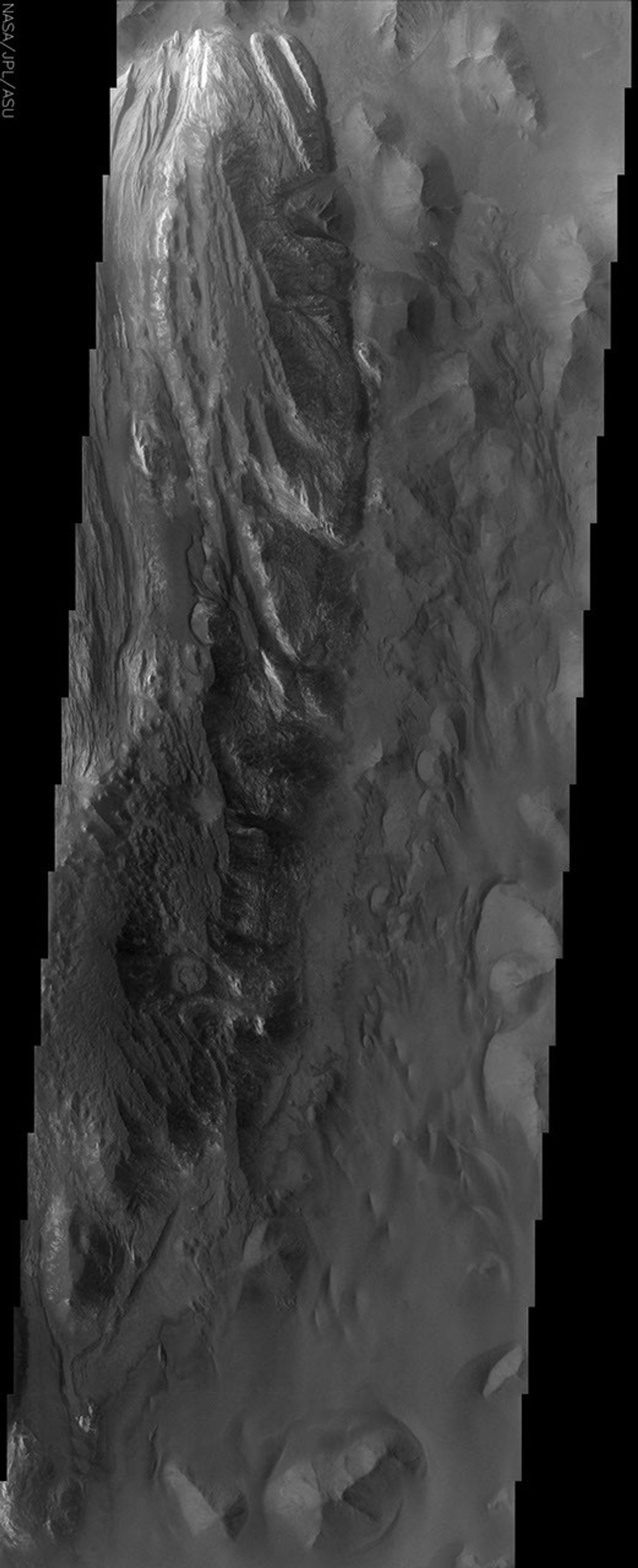 Juventae Chasma is an enormous box canyon which opens to the north and forms the outflow channel Maja Vallis. This image from NASA's Mars Odyssey spacecraft captures a portion of the western floor of Juventae Chasma and shows a wide variety of landforms.