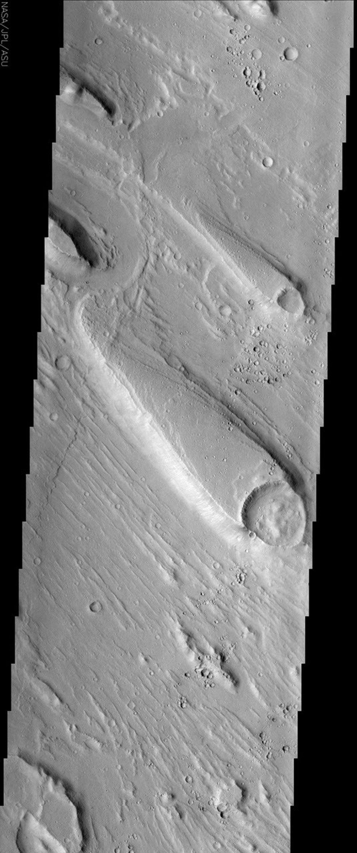 Streamlined islands, like the one shown in this NASA Mars Odyssey image, are one piece of geologic evidence that large quantities of water once flowed across the surface of Mars in the distant past.
