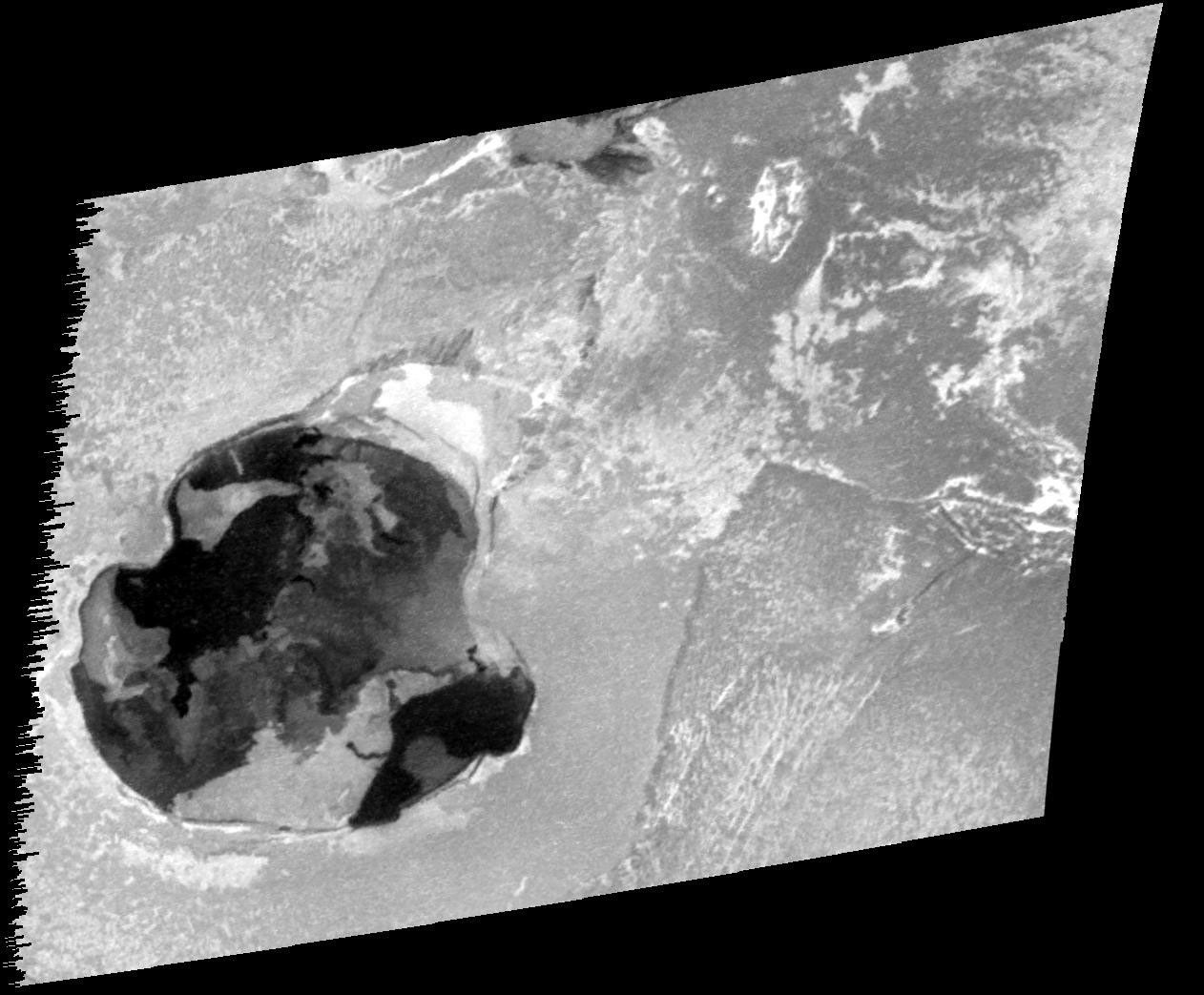 This image taken by NASA's Galileo spacecraft reveals fresh lava in a wide pit named Gish Bar Patera on Jupiter's moon Io. The patera, or depression, is quite large: 106.3 kilometers (66 miles) by 115.0 kilometers (71 miles).