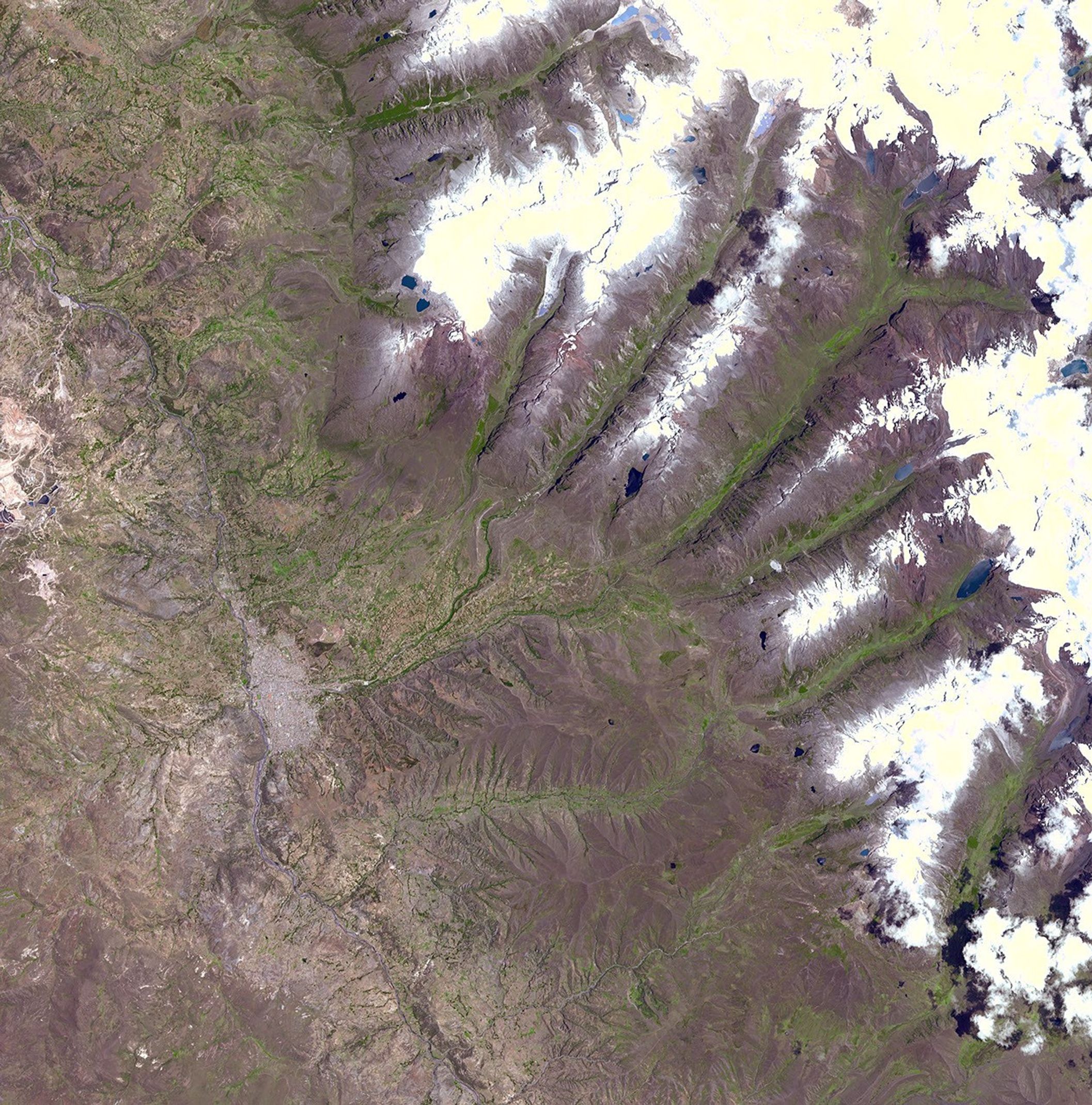 This image acquired by NASA's Terra spacecraft on November 5, 2001, shows a chunk of glacier was threatening to fall into an Andean lake and cause major flooding in Huraez, a Peruvian city of 60,000.