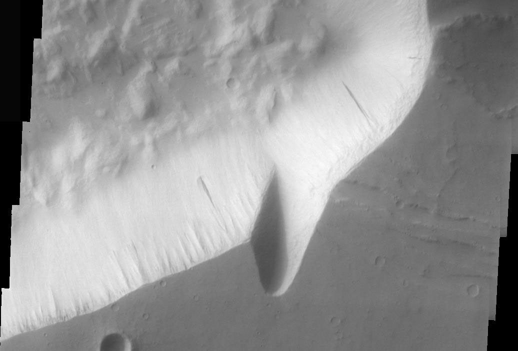 This image from NASA's Mars Odyssey spacecraft shows that dust avalanches, also called slope streaks, occur on many Martian terrains. These dust avalanches are located in Hebes Chasma.