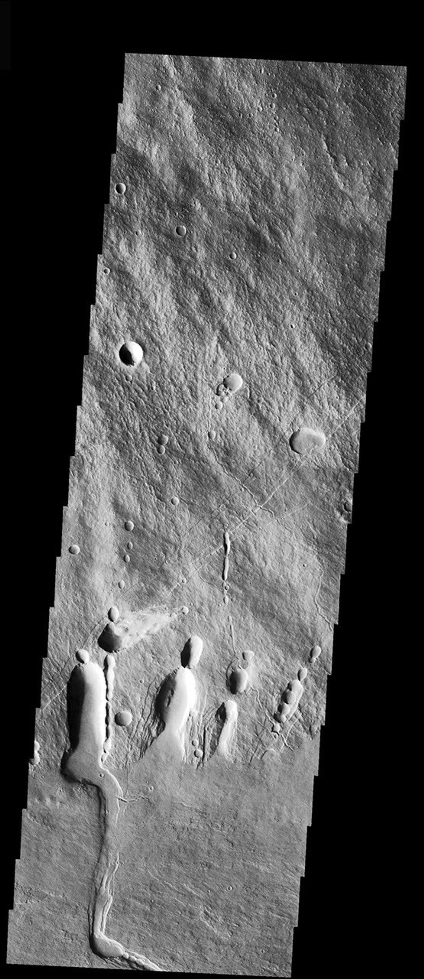 This image from NASA's Mars Odyssey spacecraft is located on the SE flank of Arsia Mons where it meets the plains. Collapse features are present at the margin of the volcano.