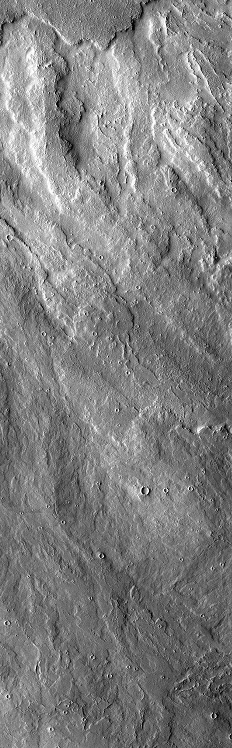 In this image from NASA's Mars Odyssey spacecraft lava flows to the west of Arsia Mons look very similar to the lava flows south of Arsia Mons. It is very likely that the flows were occurring at the same time(s) in both areas.