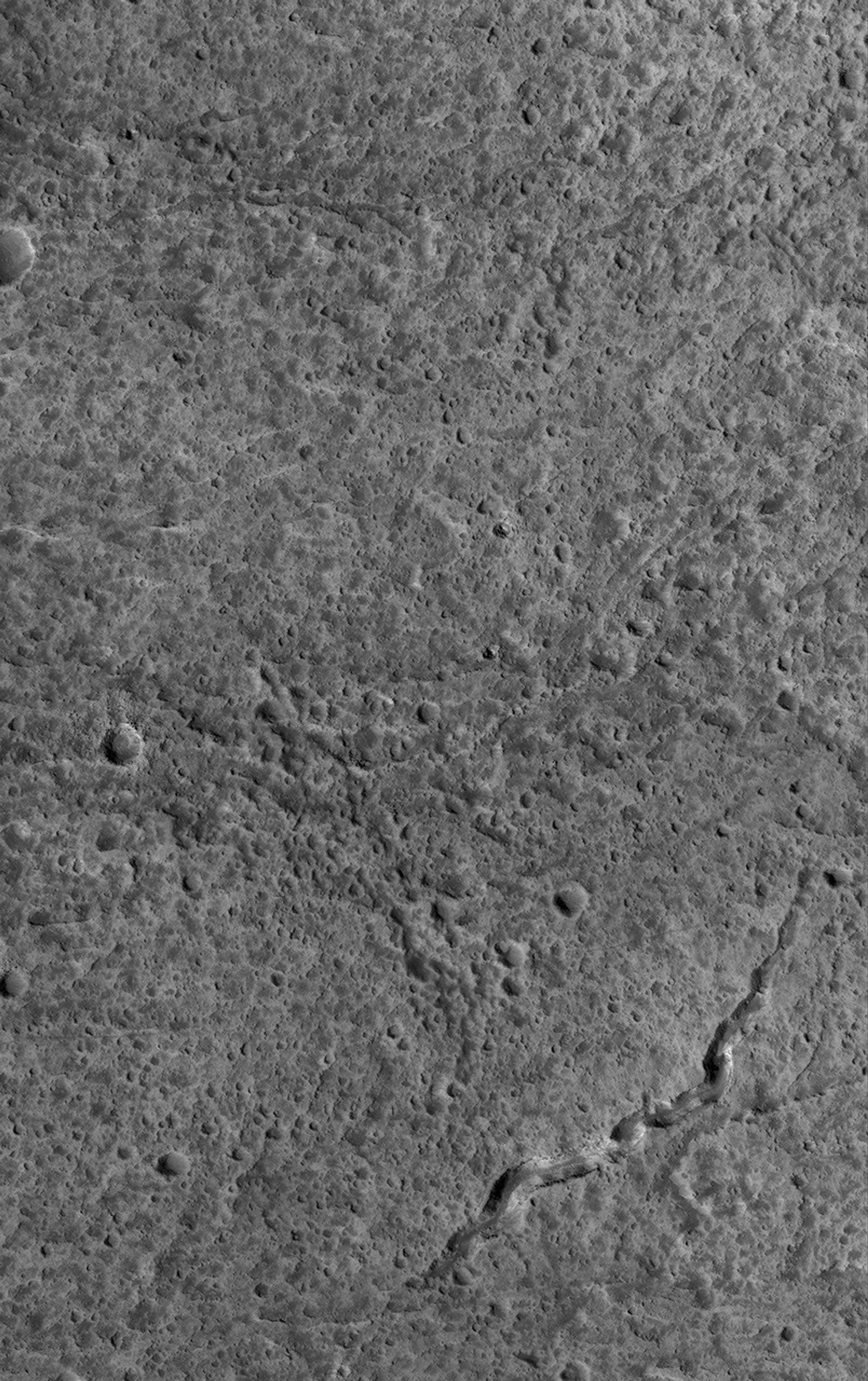 NASA's Mars Global Surveyor shows a portion of the upper west flank of the giant martian volcano, Olympus Mons. Although considered to be young relative to much of Mars, at high resolution the Olympus Mons volcano turns out to be heavily cratered.