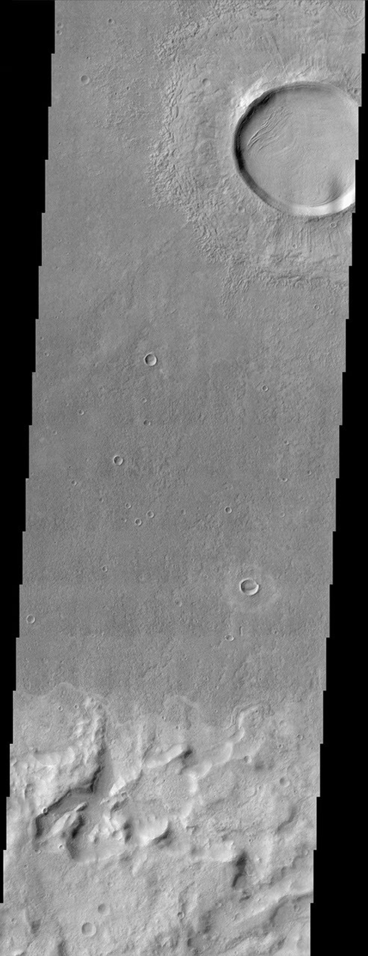 This scene from NASA's Mars Odyssey spacecraft shows several interesting geologic features associated with impact craters on Mars.