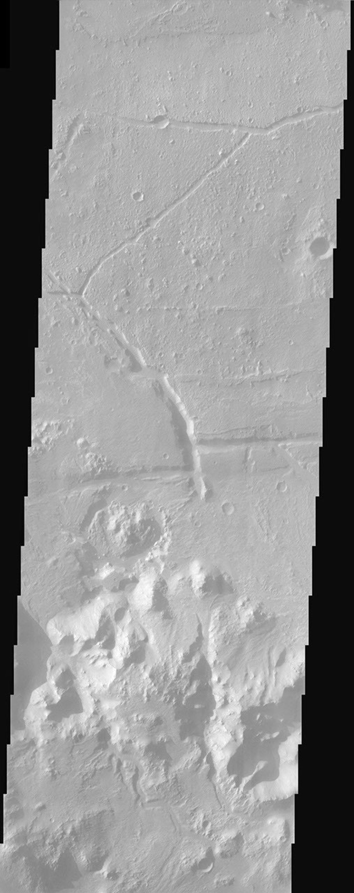Ripple bedforms fill large fractures near the southern rim of Holden Crater in this image from NASA's Mars Odyssey spacecraft.