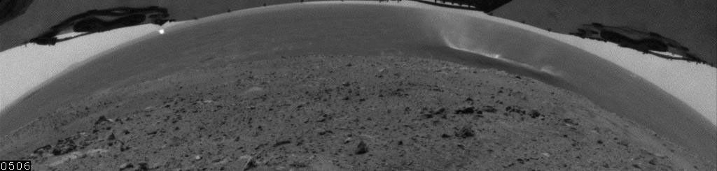 This image shows dust devils moving across the plain inside Mars' Gusev Crater, as seen with a hazard-identification camera on NASA's Mars Exploration Rover Spirit on July 29, 2005.