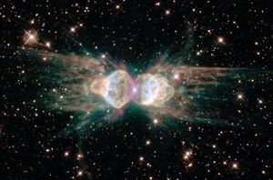 A dark starfield appears around an unusually shaped nebula. The nebula has two main lobes on the left and the right and may seem to resemble an ant.