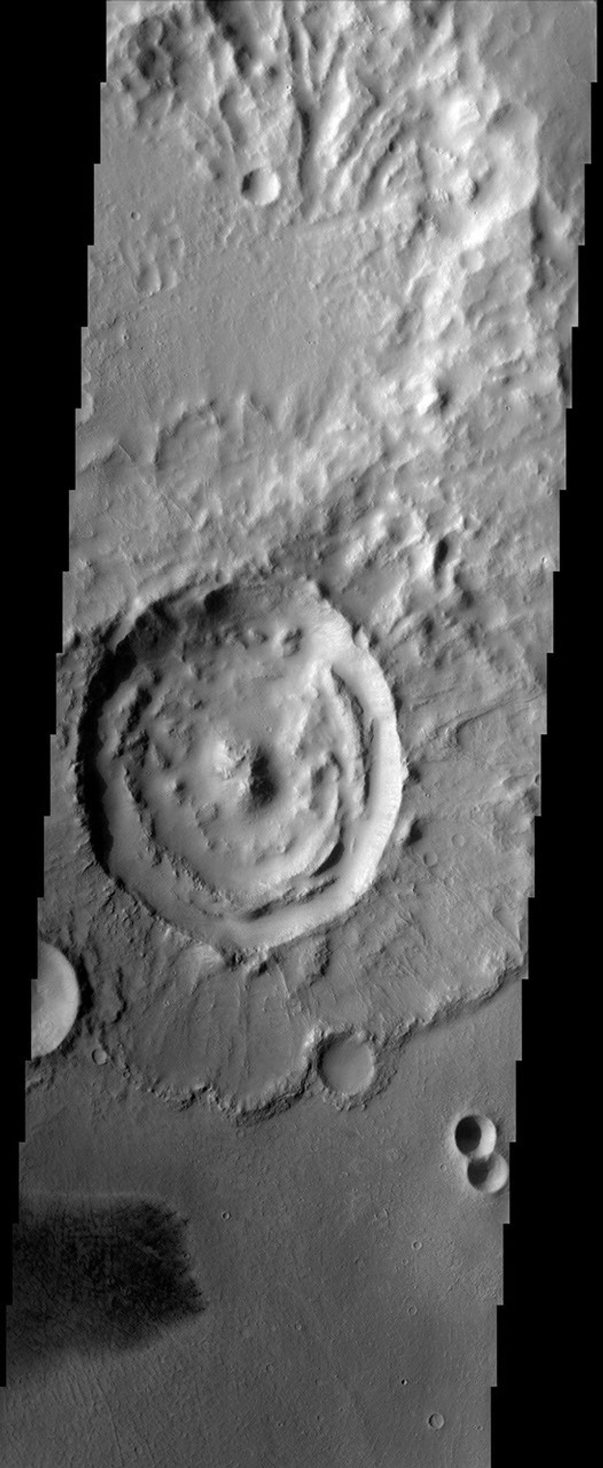 This image from NASA's Mars Odyssey spacecraft shows an impact crater with a rampart ejecta blanket in Arabia Terra.