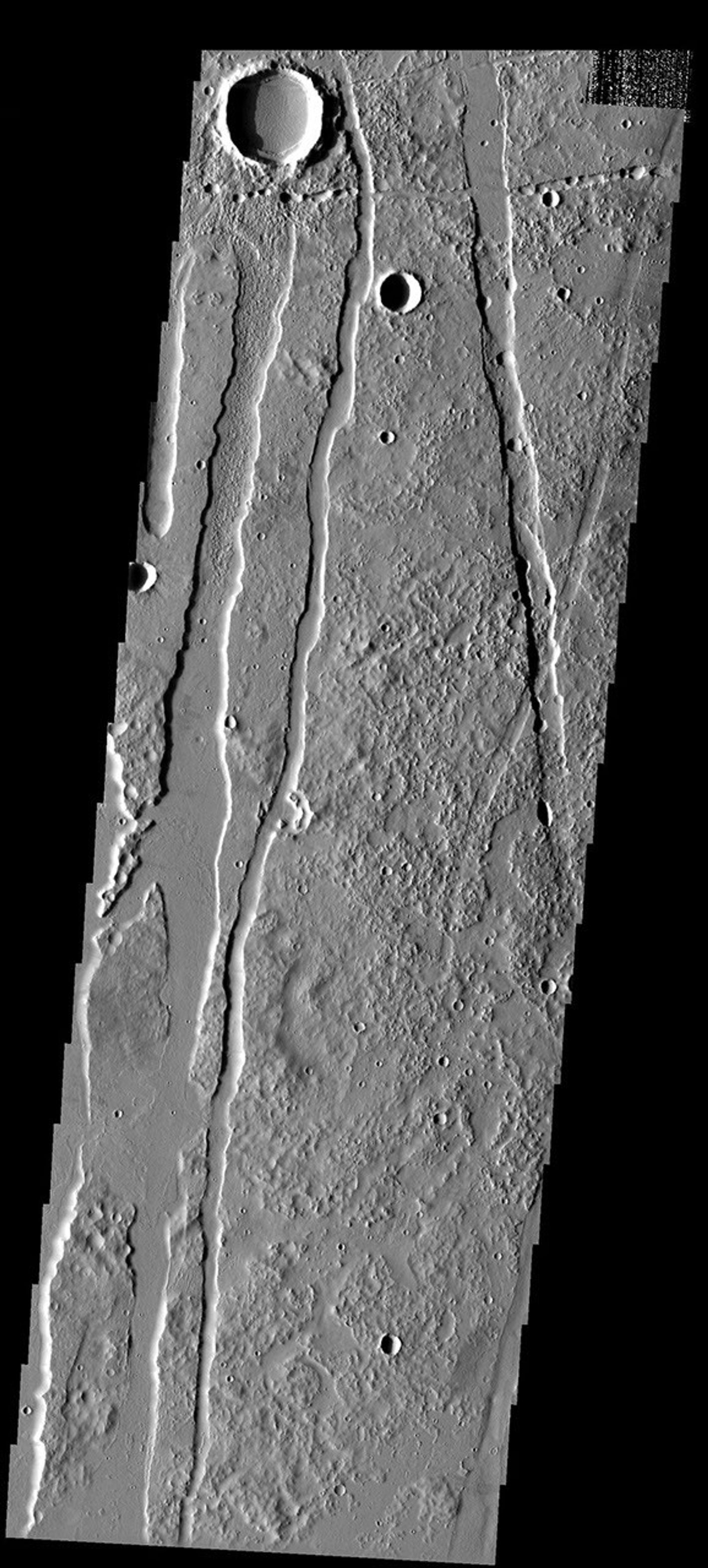 Craters, pit chains, graben, and lava flows south of Alba Patera, a volcano located within the Tharsis volcanic complex on Mars as seen by NASA's 2001 Mars Odyssey spacecraft.