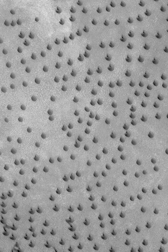 NASA's Mars Global Surveyor shows a field of small barchan sand dunes in the north polar region of Mars.