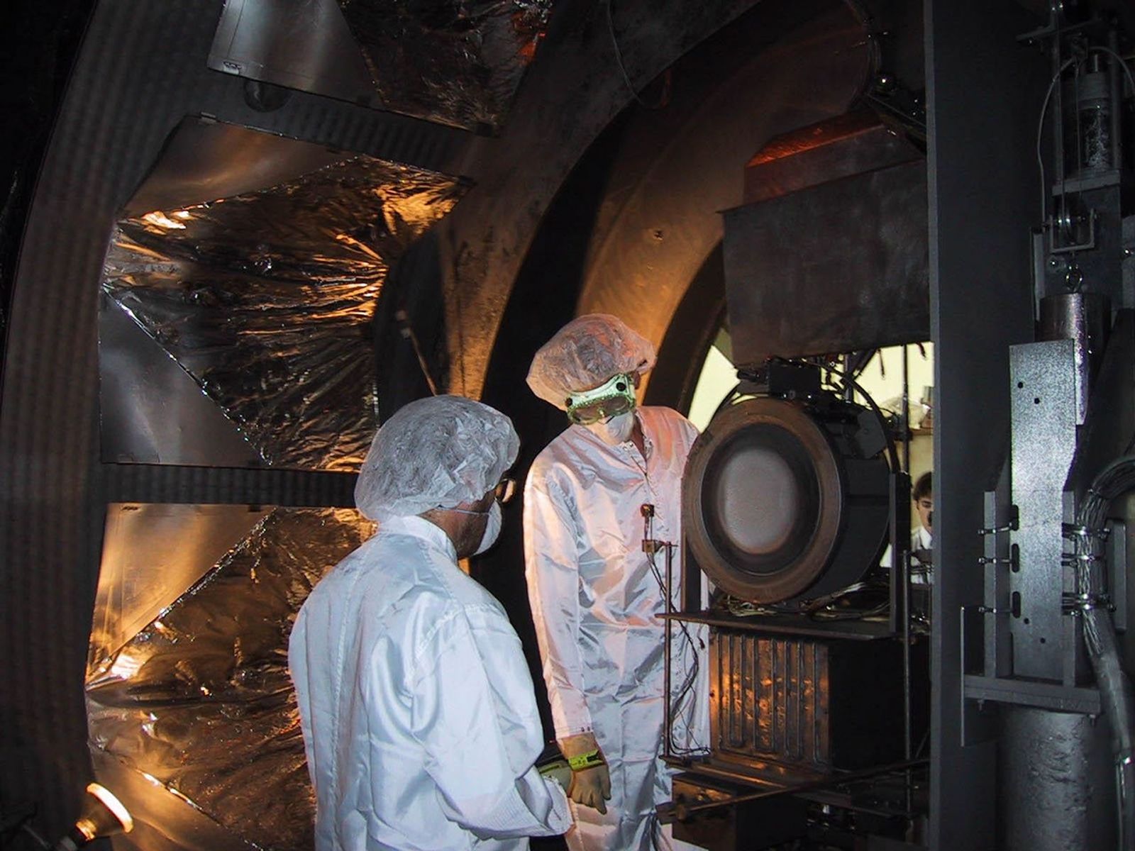 An ion thruster is removed from a vacuum chamber at NASA's Jet Propulsion Laboratory, Pasadena, Calif., its job done following almost five years of testing.