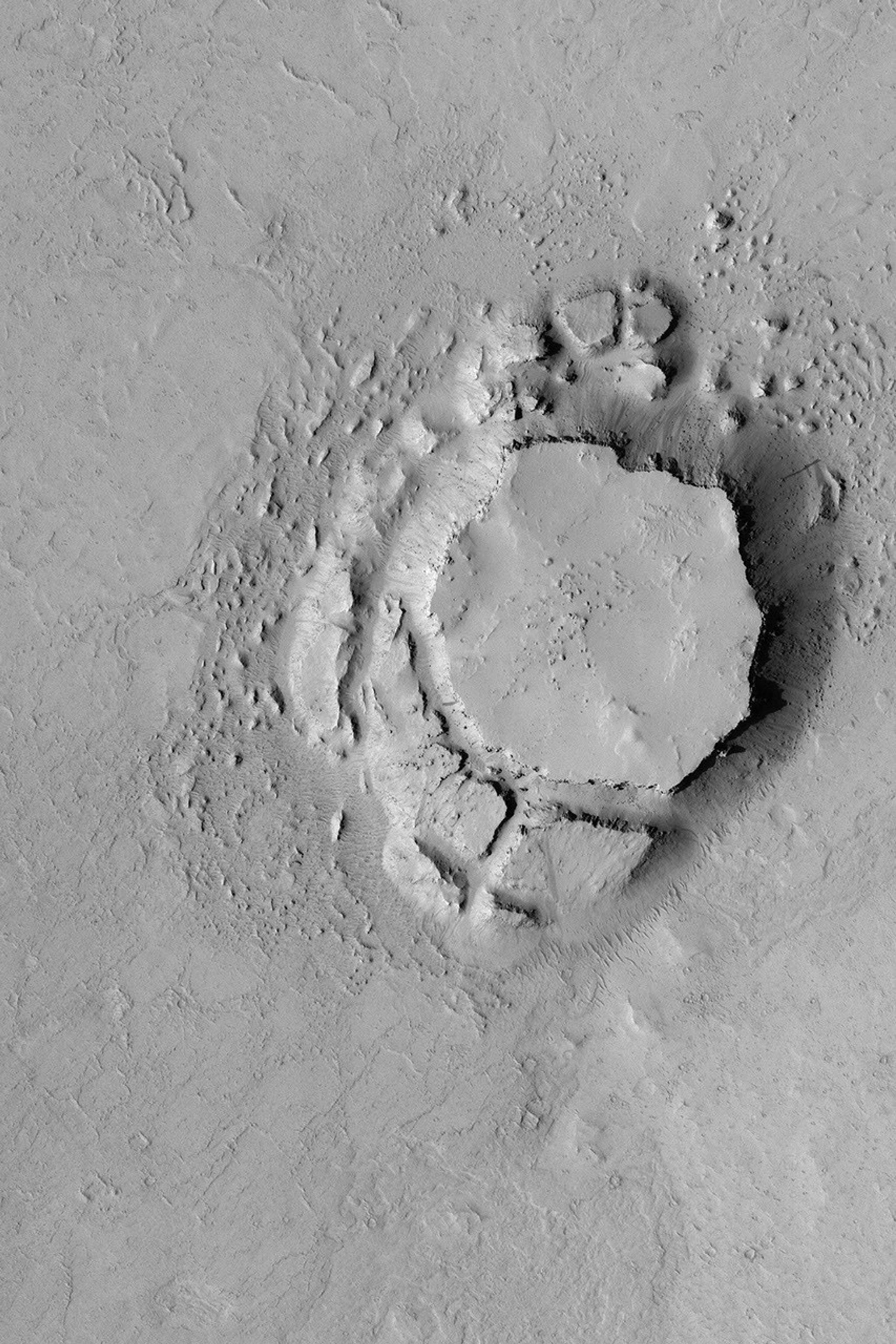NASA's Mars Global Surveyor shows a mesa in the Avernus Colles region of Mars. The mesa and very large blocks that have been shed from its slopes are evident.