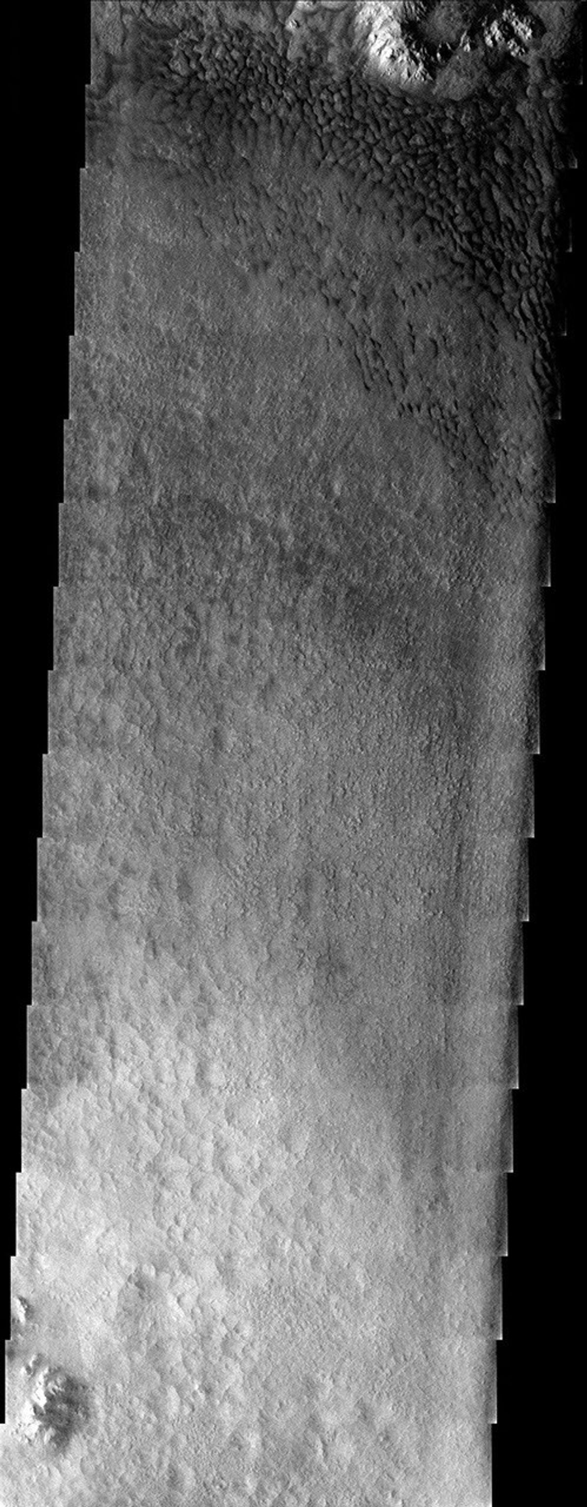 NASA's Mars Odyssey spacecraft captured this image in August 2003, showing the floor of a crater just north of the Argyre basin in the southern hemisphere. Dark dunes have been pushed up against the northeastern interior rim of the crater on Mars.