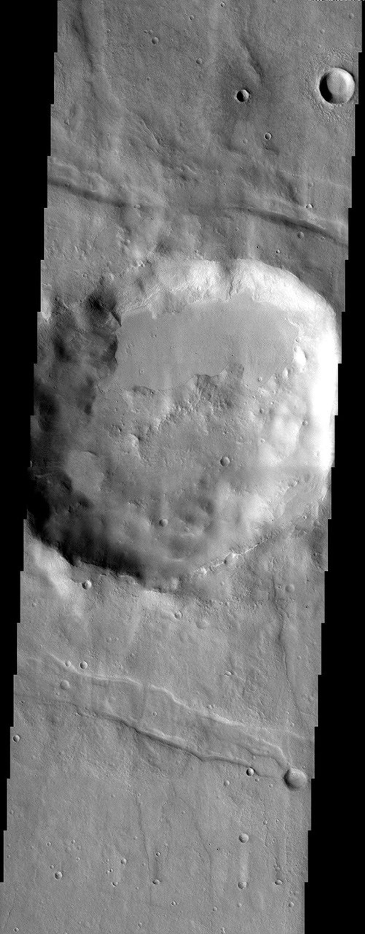 NASA's Mars Odyssey spacecraft captured this image in August 2003, showing a crater on Mars in the rugged Thaumasia uplands surrounding Solis Lacus containing an unusual filling of smooth material ramped up against the crater rim.