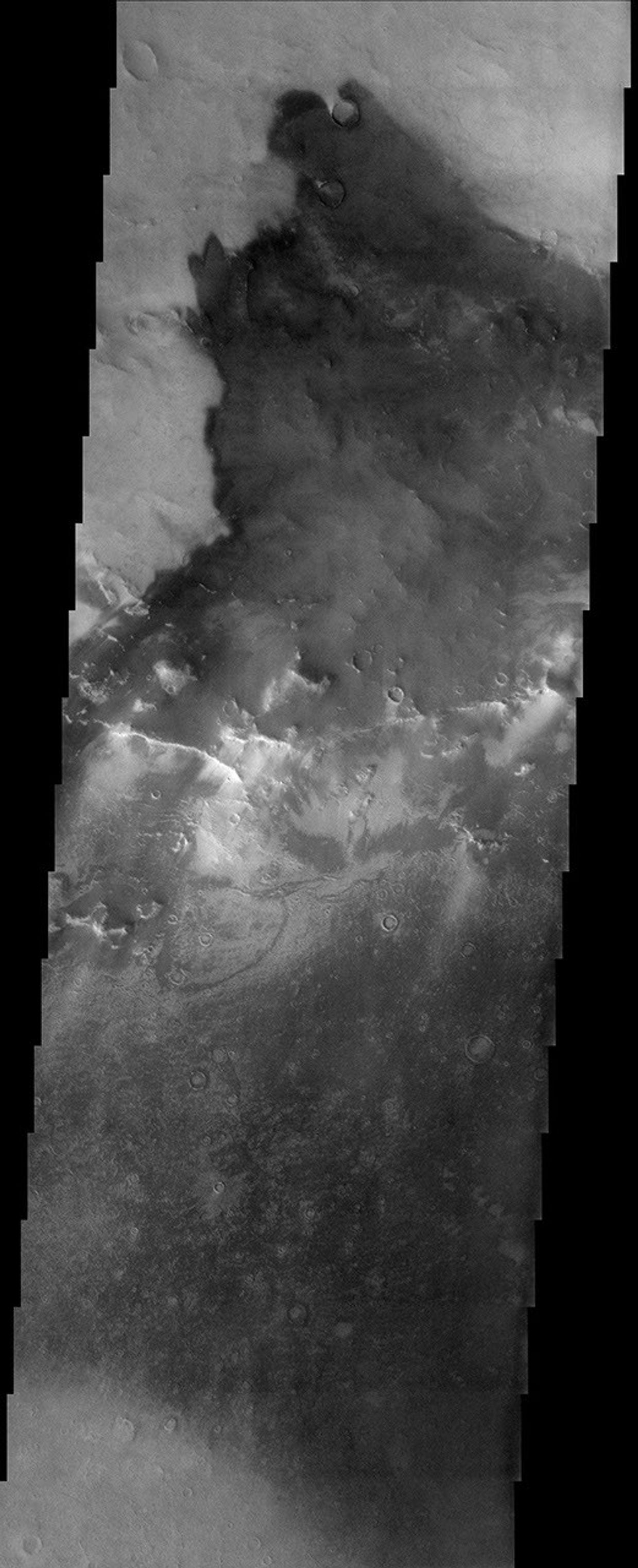 The bright and dark tones in this image taken November 2003 by NASA's Mars Odyssey spacecraft are part of an unnamed impact crater near the larger impact crater Schiaparelli are due to variable amounts of bright dust and dark sand covering the surface.