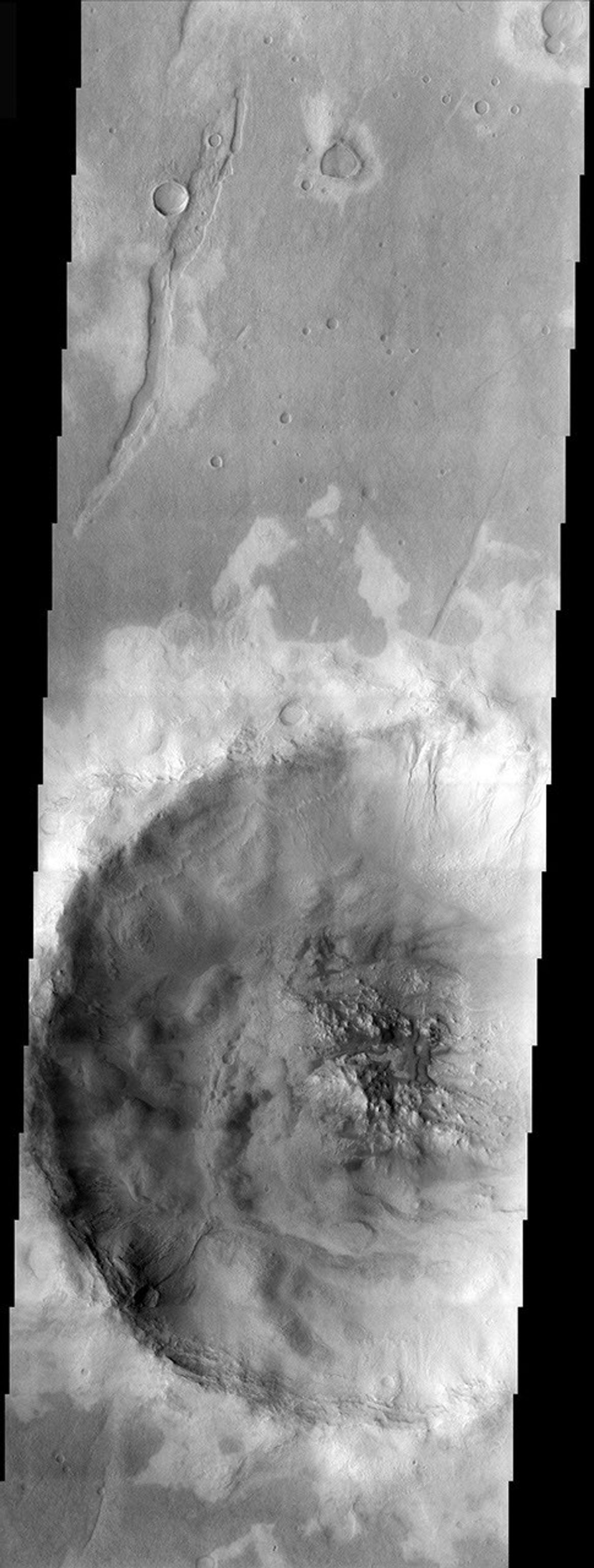 This image from NASA's 2001 Mars Odyssey released on Dec 23, 2003 shows an unnamed crater west of Icaria Planum hosts an even smaller crater with interesting features both inside and out. A strange pattern of light-toned surfaces appears.