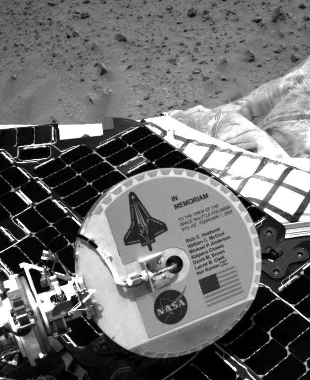 A plaque commemorating the astronauts who died in the tragic accident of the Space Shuttle Columbia is mounted on the back of NASA's Mars Exploration Rover Spirit's high-gain antenna.