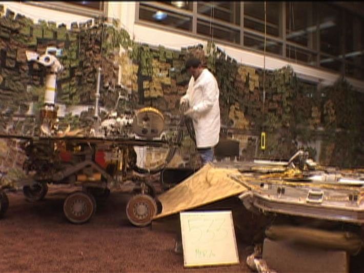 Footage from the JPL In-Situ Instruments Laboratory, or 'testbed,' shows engineers rehearsing a crucial maneuver called egress in which NASA's Mars Exploration Rover Spirit rolls off its lander platform and touches martian soil.