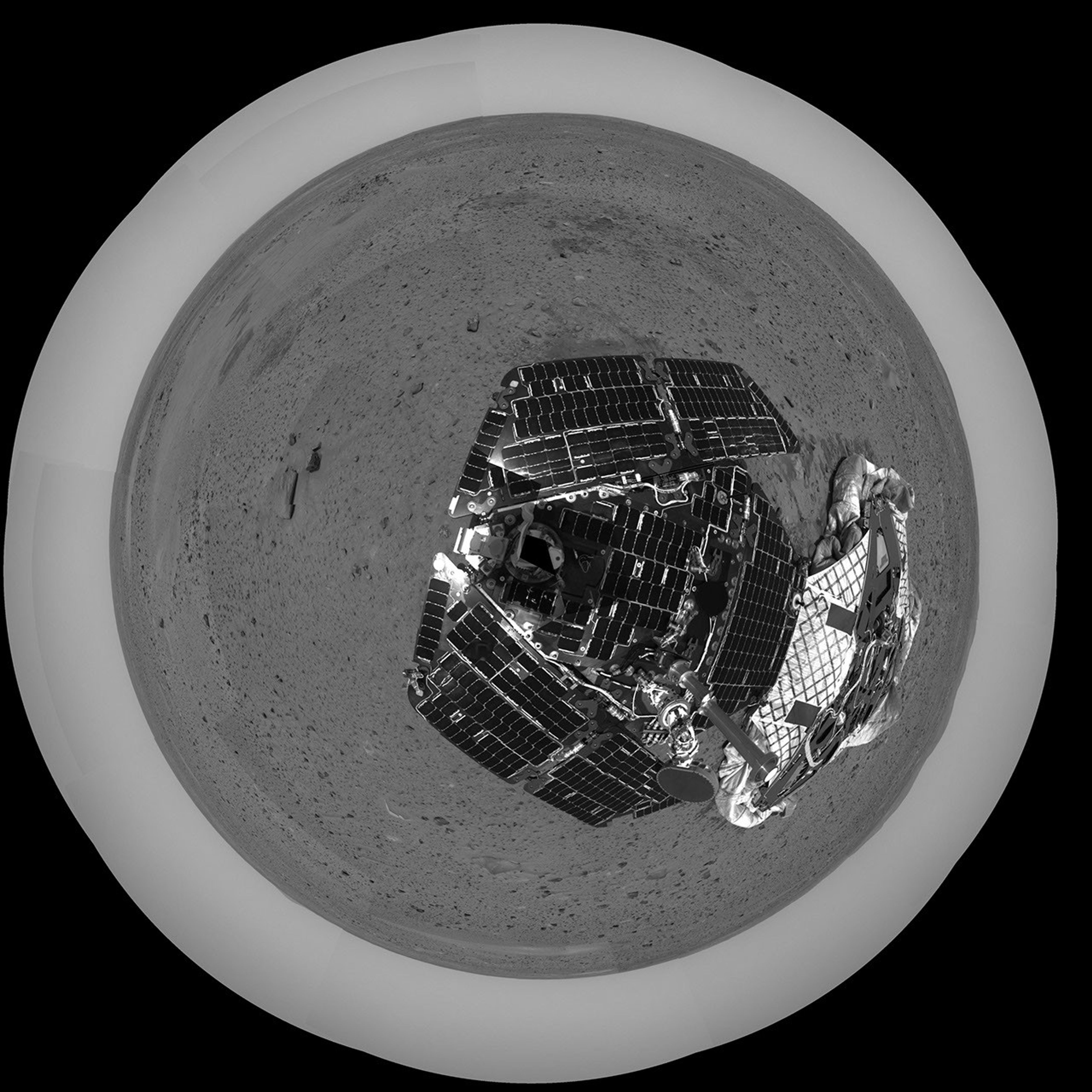 This overhead polar image was captured after NASA's Mars Exploration Rover Spirit took a few baby rolls away from the spacecraft that bore it millions of miles to Mars in 2004. The empty lander is seen to the right of the rover.