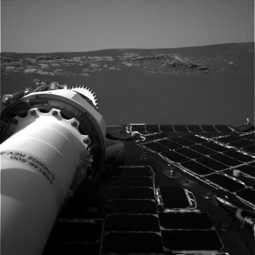 NASA's Mars Exploration Rover Opportunity's first breathtaking views of the martian landscape after its successful landing at Meridiani Planum on Mars. On the left, the rover's mast can be seen in a stowed position.