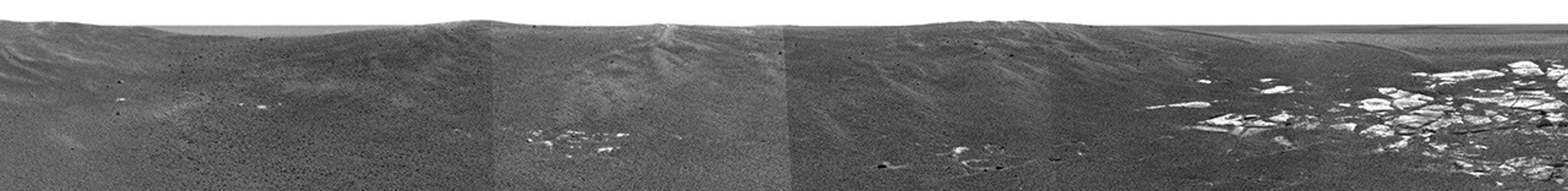 NASA's Mars Exploration Rover Opportunity highlights the flat and dark terrain of its landing site at Meridiani Planum.