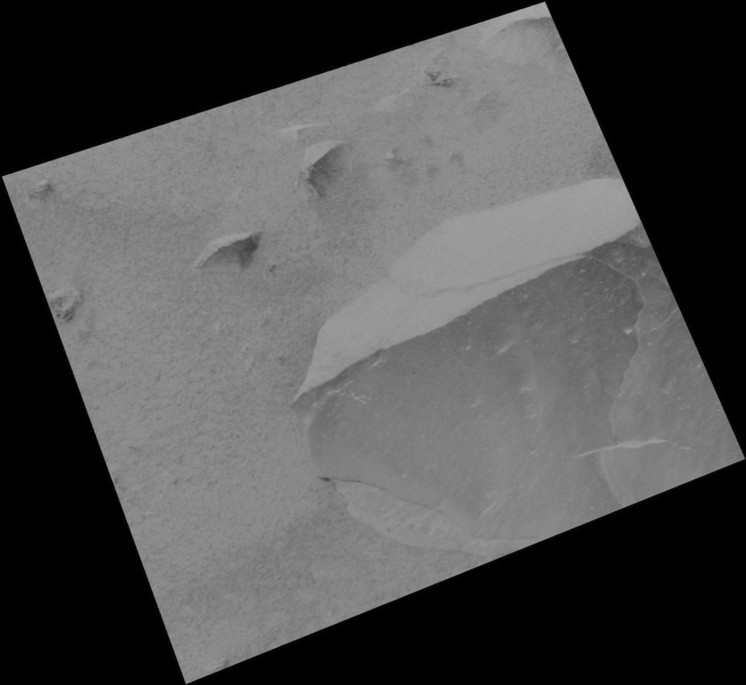 NASA's Mars Exploration Rover Spirit shows the rock dubbed Adirondack before the rover wiped off a portion of the rock's dust coating with a stainless steel brush located on its rock abrasion tool.
