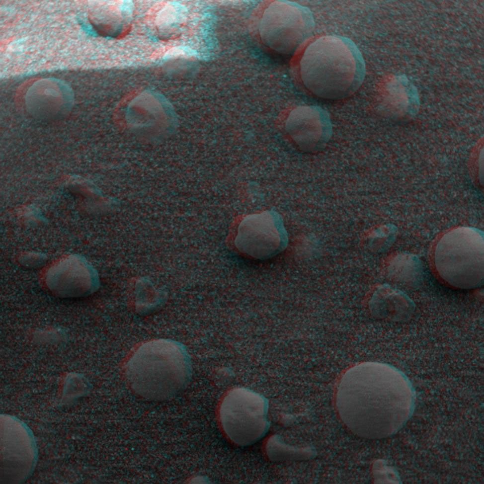 This 3-D anaglyph, from NASA's Mars Exploration Rover Spirit, shows an extreme close-up of round, blueberry-shaped grains on the crater floor near the rock outcrop at Meridiani Planum called Stone Mountain. 3D glasses are necessary.