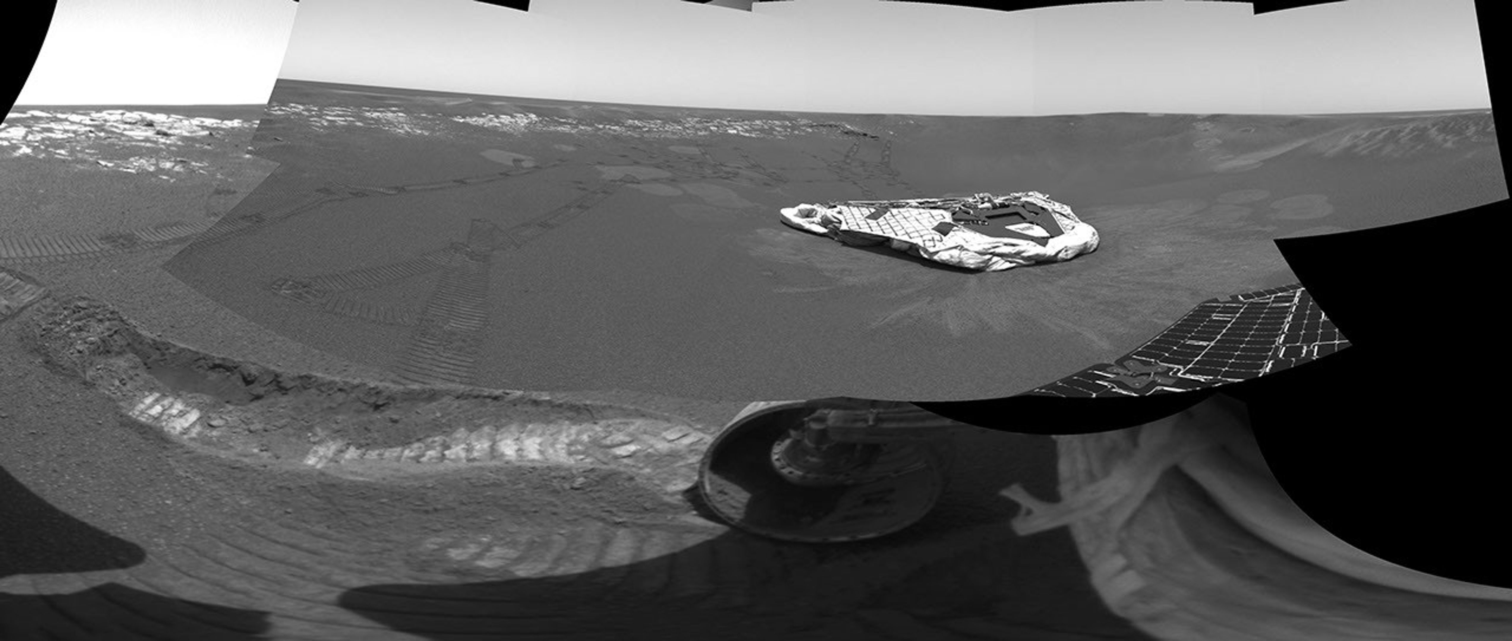 NASA's Mars Exploration Rover Opportunity dragged one of its wheels back and forth across the sandy soil at Meridiani Planum to create a hole.