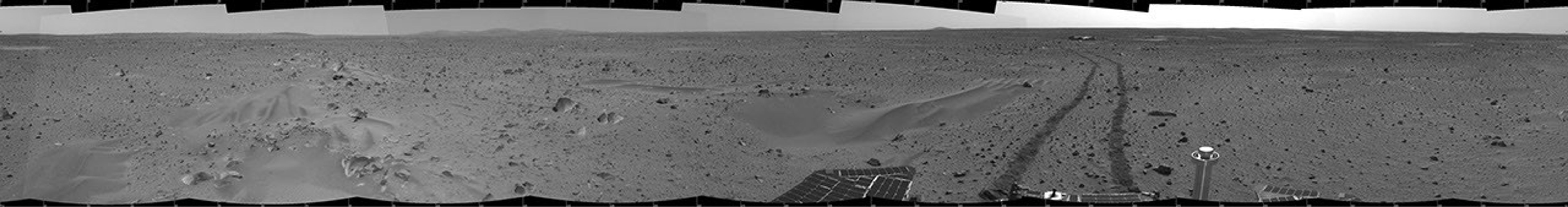 This 360-degree mosaic panorama image, taken by the navigation camera onboard NASA's Mars Exploration Rover Spirit, includes a view of the lander. The lander is to the south-southwest of the rover, which is moving toward a crater nicknamed 'Bonneville.'