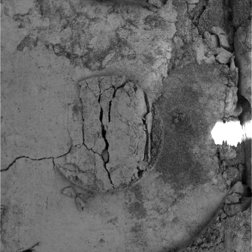 NASA's Mars Exploration Rover Opportunity shows the imprint of the donut-shaped plate on the rover's Moessbauer spectrometer instrument, located on rover's the 'arm.' The rover was investigating fine-grained soil for iron-bearing minerals.