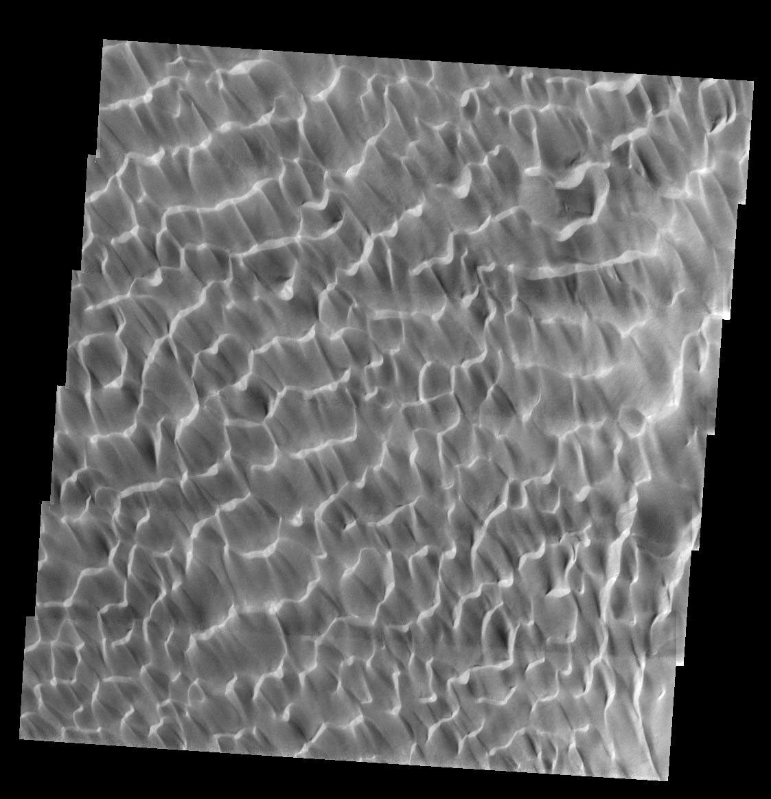 This image, part of an images as art series from NASA's 2001 Mars Odyssey released on Feb 7, 2004 shows sunlight reflecting off martian dunes giving a very aquatic feel to this area, as if looking at ripples of water.