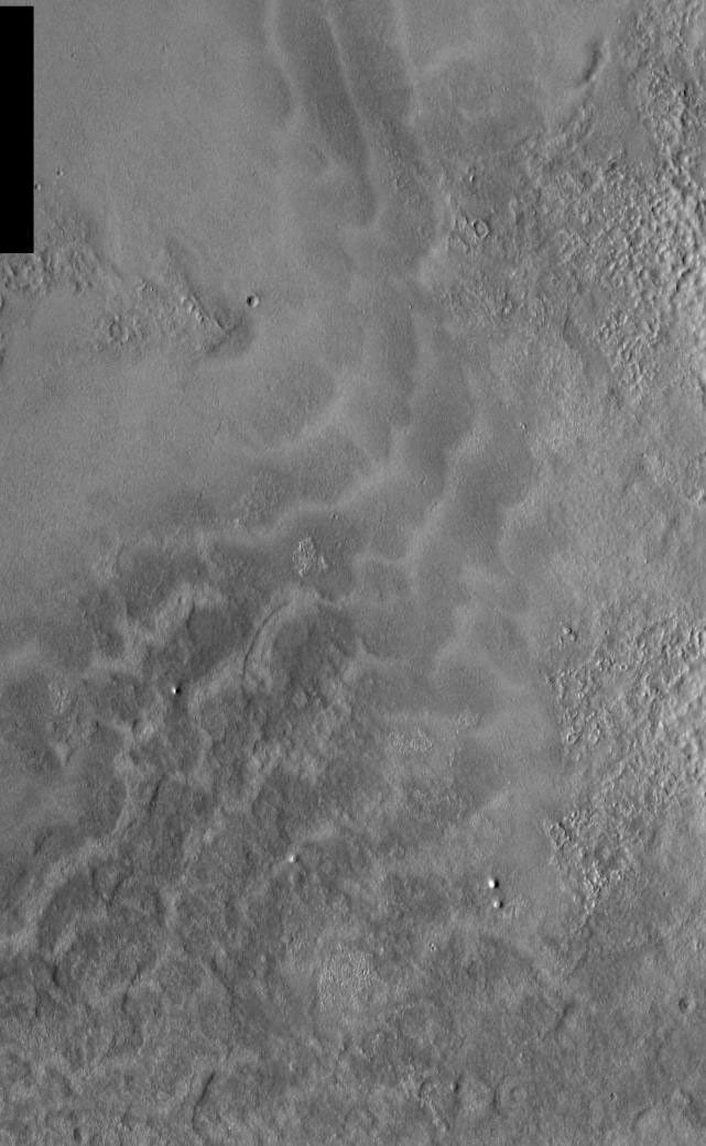 This image, part of an images as art series from NASA's 2001 Mars Odyssey released on Feb 10, 2004 shows sunlight reflecting off martian dunes giving a very aquatic feel to this area, like waves washing up on the beach.