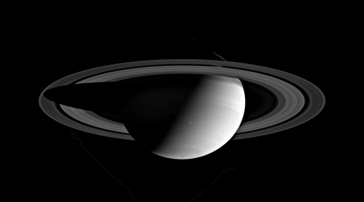 This image captured by NASA's Cassini spacecraft shows a glance back at Saturn, taking in the entire planet and its expansive rings.