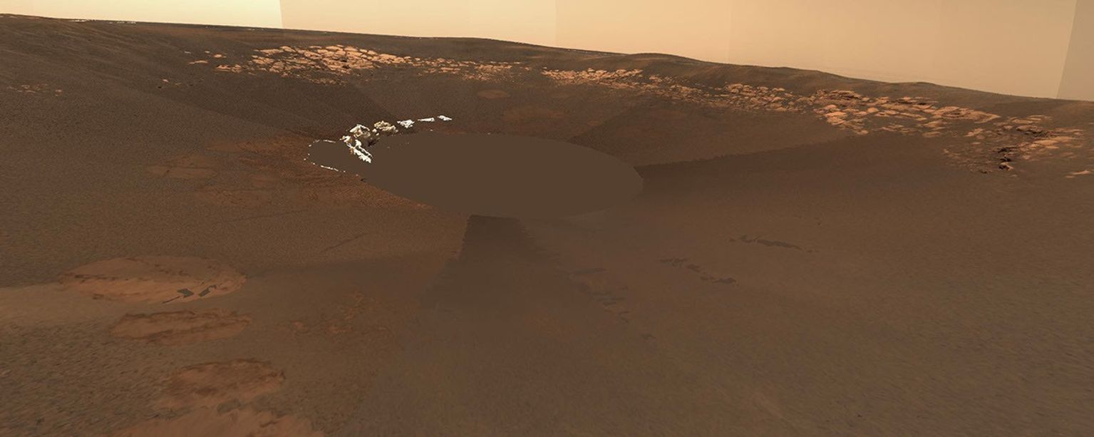 The rocky outcrop traversed by NASA's Mars Exploration Rover Opportunity is visible in this 3-dimensional model of the rover's landing site. The white crumpled fragments are portions of the rover's airbags.