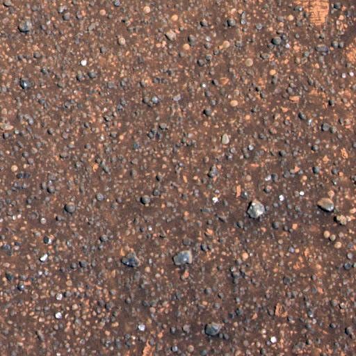 NASA's Mars Exploration Rover Opportunity shows a region of the rock outcrop at Meridiani Planum, Mars, dubbed 'Charlie Flats.' This region contains a diverse assortment of small grains, pebbles and spherules, and both dark and light soil deposits.