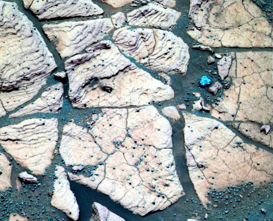 This image, taken at a region of the rock outcrop dubbed 'Shoemaker's Patio' near NASA's Mars Exploration Rover Opportunity's landing site, shows finely layered sediments, accentuated by erosion and sphere-like grains or 'blueberries.'