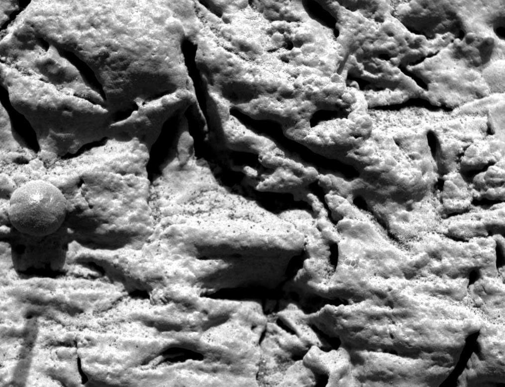 This microscopic image was taken at the outcrop region dubbed 'El Capitan' near NASA's Mars Exploration Rover Opportunity's landing site reveals millimeter-scale layers running horizontally.